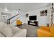 Living room with off-white sofa and mustard armchairs at 2516 Nouveau Way, Kissimmee, FL 34741