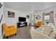 Living room with off-white sofa, fireplace, and armchairs at 2516 Nouveau Way, Kissimmee, FL 34741