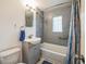 Updated bathroom with gray hex tile and a tub shower combo at 277 Debary Dr, Debary, FL 32713