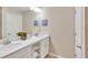Double vanity bathroom with white cabinets and a large mirror at 3151 Paradox Cir # 107, Kissimmee, FL 34746