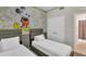 Two twin beds in a Mickey Mouse themed bedroom at 3151 Paradox Cir # 107, Kissimmee, FL 34746