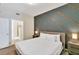 King-size bed in a bedroom with gray accent wall at 3151 Paradox Cir # 107, Kissimmee, FL 34746