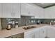 Modern kitchen with white cabinets and gray tile backsplash at 3151 Paradox Cir # 107, Kissimmee, FL 34746