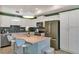 Modern kitchen with stainless steel appliances and an island at 3151 Paradox Cir # 107, Kissimmee, FL 34746