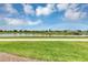 View of a pond and green space with a walking path at 3151 Paradox Cir # 107, Kissimmee, FL 34746