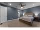 Spacious bedroom with wood bed frame and neutral color scheme at 4558 Lions Gate Ave, Clermont, FL 34711