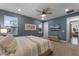Primary bedroom with ensuite bathroom, ceiling fan, and access to balcony at 4558 Lions Gate Ave, Clermont, FL 34711