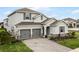 Two-story house with gray siding and stone accents at 4558 Lions Gate Ave, Clermont, FL 34711