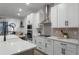 Modern kitchen with white cabinets, stainless steel appliances, and quartz countertops at 4558 Lions Gate Ave, Clermont, FL 34711