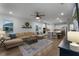 Open concept living room with sectional sofa and view of the kitchen at 4558 Lions Gate Ave, Clermont, FL 34711