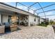Covered patio with pavers, seating area, and screened enclosure at 4558 Lions Gate Ave, Clermont, FL 34711