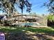 Inviting backyard oasis with screened pool, patio, and lush landscaping at 506 Little Wekiva Rd, Altamonte Springs, FL 32714