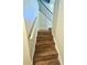 Modern stairway with wood-look tile steps and a sleek black iron railing at 506 Little Wekiva Rd, Altamonte Springs, FL 32714