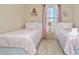 Bedroom with two twin beds, nightstand and window at 5120 Adelaide Dr, Kissimmee, FL 34746