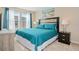 King-size bed in bright bedroom with large windows at 5120 Adelaide Dr, Kissimmee, FL 34746