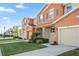Two-story townhome with light orange exterior and attached garage at 5120 Adelaide Dr, Kissimmee, FL 34746
