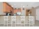 Island kitchen with light wood cabinets, granite countertops, and breakfast bar at 5120 Adelaide Dr, Kissimmee, FL 34746