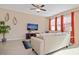 Spacious living room with beige sofa and large flat-screen TV at 5120 Adelaide Dr, Kissimmee, FL 34746