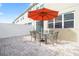 Outdoor patio furniture under a large umbrella at 5120 Adelaide Dr, Kissimmee, FL 34746