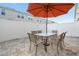 Patio with table, chairs, and an orange umbrella at 5120 Adelaide Dr, Kissimmee, FL 34746