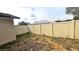 Side yard with beige vinyl fence at 513 Greenbrough Dr, Lake Wales, FL 33853