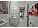 Clean bathroom with white vanity, marble floor, and Disney decor at 532 Hunter Cir, Kissimmee, FL 34758