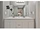 Modern bathroom with a double vanity and marble-look flooring at 532 Hunter Cir, Kissimmee, FL 34758