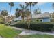 Exterior view of light blue building with palm trees and landscaping at 701 Glasgow Ct # 701, Winter Springs, FL 32708