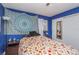 Blue bedroom with a double bed and large tapestry at 716 Katherine St, South Daytona, FL 32119