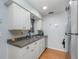 Clean kitchen featuring white cabinets and dark countertops at 716 Katherine St, South Daytona, FL 32119