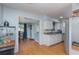 Bright kitchen with white cabinets, stainless steel appliances, and laminate flooring at 716 Katherine St, South Daytona, FL 32119