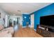 Bright living room with hardwood floors and a blue accent wall at 716 Katherine St, South Daytona, FL 32119