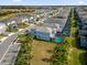 Aerial view of community with lake and homes with pools at 7260 Oakmoss Loop, Davenport, FL 33837