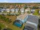 Aerial view of house and community, showcasing pool and landscaping at 7260 Oakmoss Loop, Davenport, FL 33837