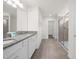 Large bathroom with double vanity, granite countertop, and walk-in shower at 7260 Oakmoss Loop, Davenport, FL 33837
