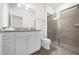 Clean bathroom with granite countertop, white cabinets and shower at 7260 Oakmoss Loop, Davenport, FL 33837