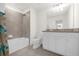 Bathroom with tub/shower combo, granite countertop vanity at 7260 Oakmoss Loop, Davenport, FL 33837