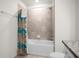 Clean bathroom with tub and shower combination at 7260 Oakmoss Loop, Davenport, FL 33837