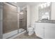Bathroom with shower, toilet and white vanity at 7260 Oakmoss Loop, Davenport, FL 33837