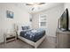 Bright bedroom with a queen bed, TV and nightstand at 7260 Oakmoss Loop, Davenport, FL 33837