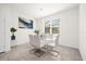 Bright dining area with glass table and white chairs at 7260 Oakmoss Loop, Davenport, FL 33837