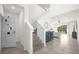 Staircase and entryway with view into the living room at 7260 Oakmoss Loop, Davenport, FL 33837