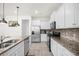 Modern kitchen with stainless steel appliances and granite countertops at 7260 Oakmoss Loop, Davenport, FL 33837