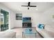 Living room with sectional sofa and glass top coffee table at 7260 Oakmoss Loop, Davenport, FL 33837