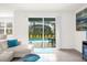 Living room with sliding glass doors leading to a pool at 7260 Oakmoss Loop, Davenport, FL 33837