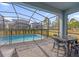 Screened pool and patio furniture at 7260 Oakmoss Loop, Davenport, FL 33837