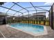 Inviting screened pool with paver deck at 7260 Oakmoss Loop, Davenport, FL 33837