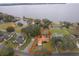 Aerial view of a house near the lake with a large lot at 808 N Shore Dr, Leesburg, FL 34748