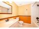 Clean bathroom with orange and beige color scheme at 808 N Shore Dr, Leesburg, FL 34748