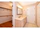 Bathroom with vanity and access to a walk-in closet at 808 N Shore Dr, Leesburg, FL 34748